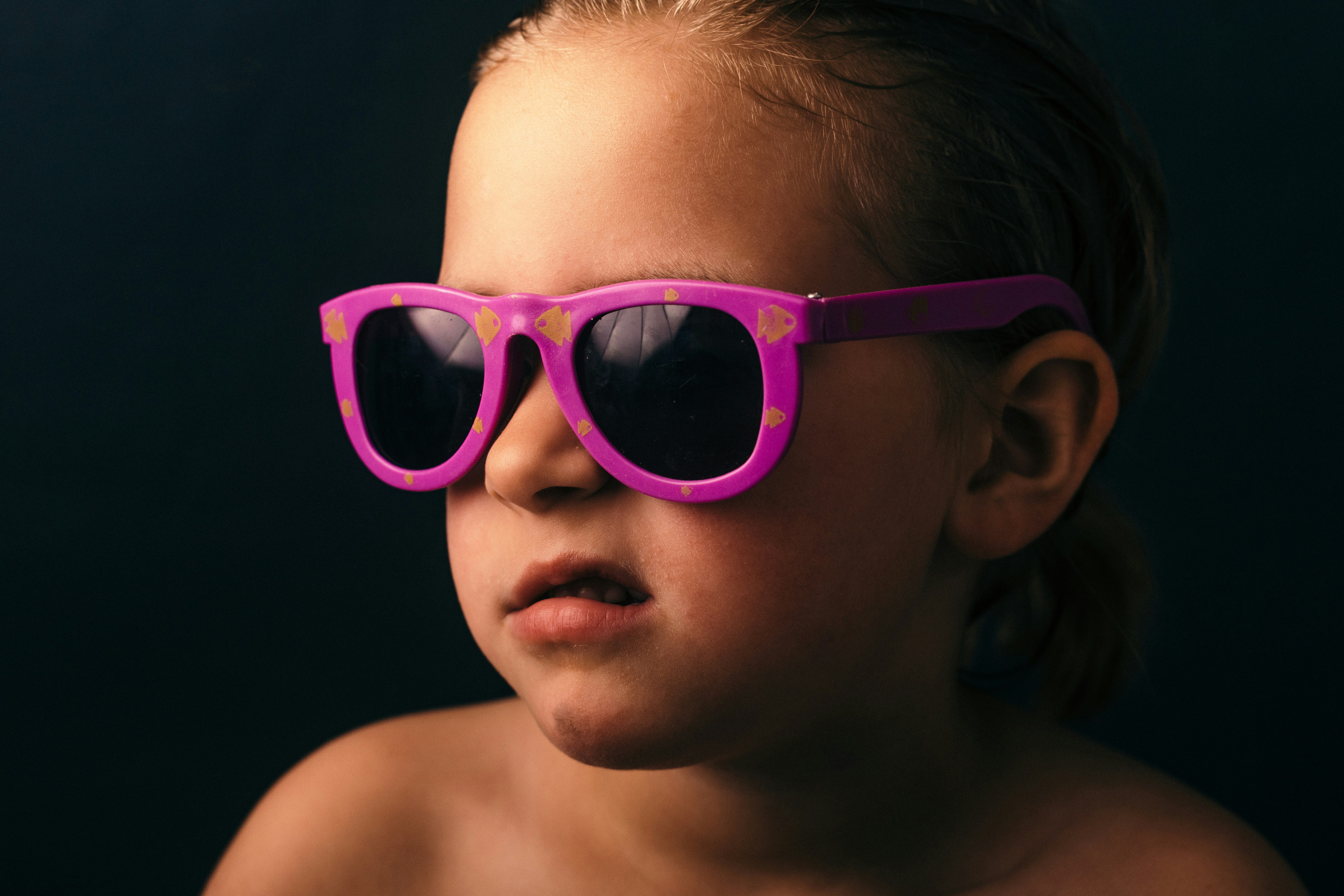 girl wearing pink framed sunglasses